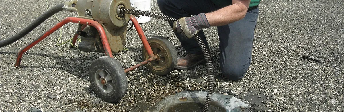 sewer rodding technician actively removing blockages from a sewer line in Albany, NY